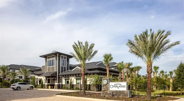 a front view of a building with palm trees