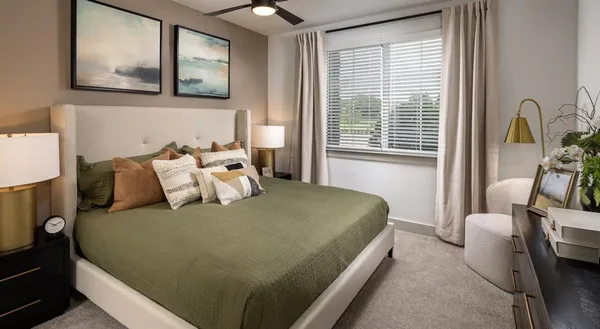 a bed sitting in a bedroom next to a window