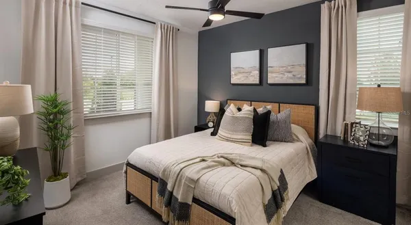 a bedroom with bed and windows