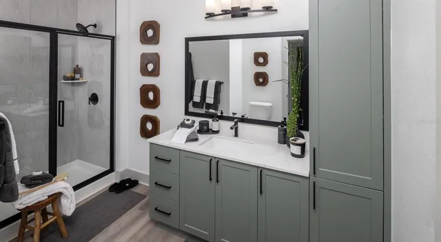 a bathroom with a sink mirror and shower