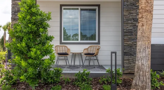 a view of a patio with table and chairs and potted plants
