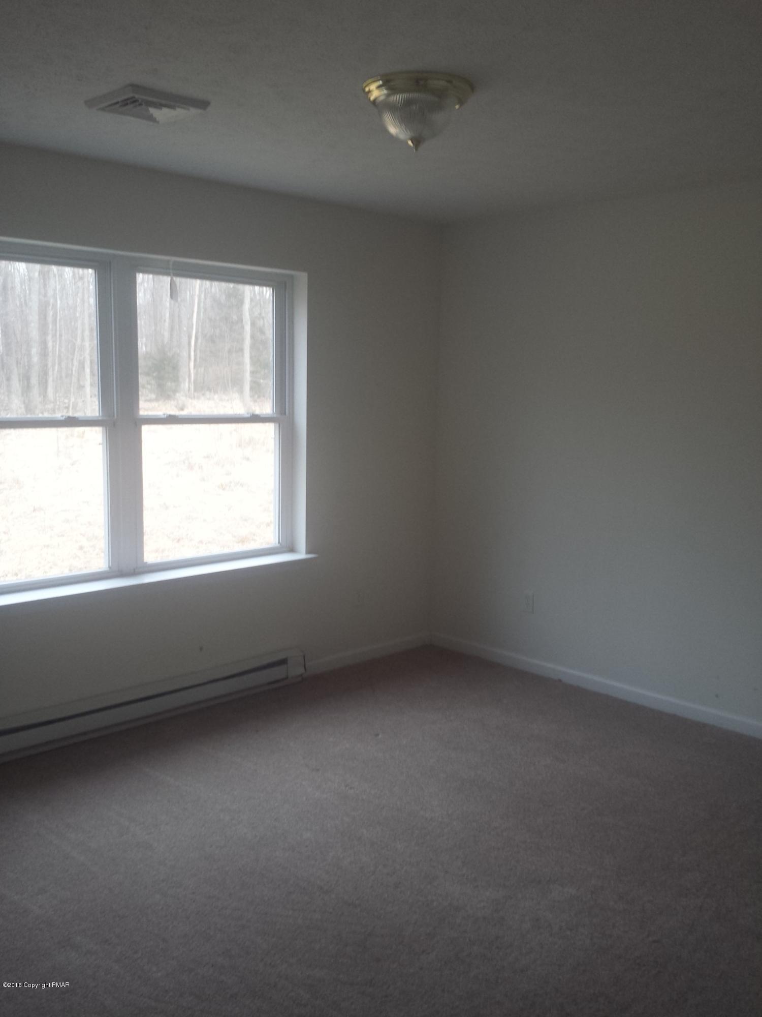 276 Powder Horn Road Henryville, PA 18332 - Photo 12 of 16 an empty room with a window