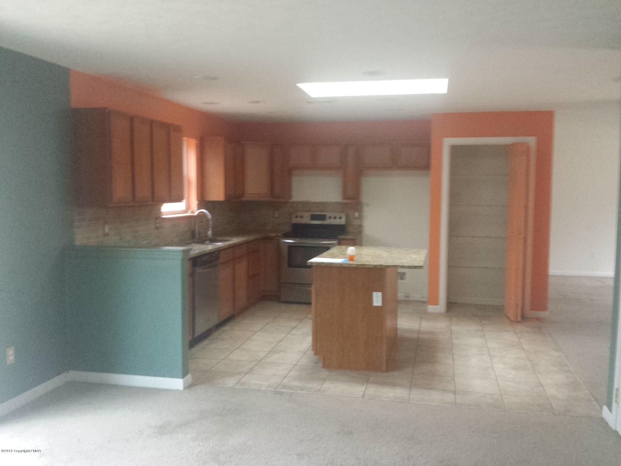 276 Powder Horn Road Henryville, PA 18332 - Photo 2 of 16 a kitchen with stainless steel appliances a sink a stove a refrigerator cabinets and a window