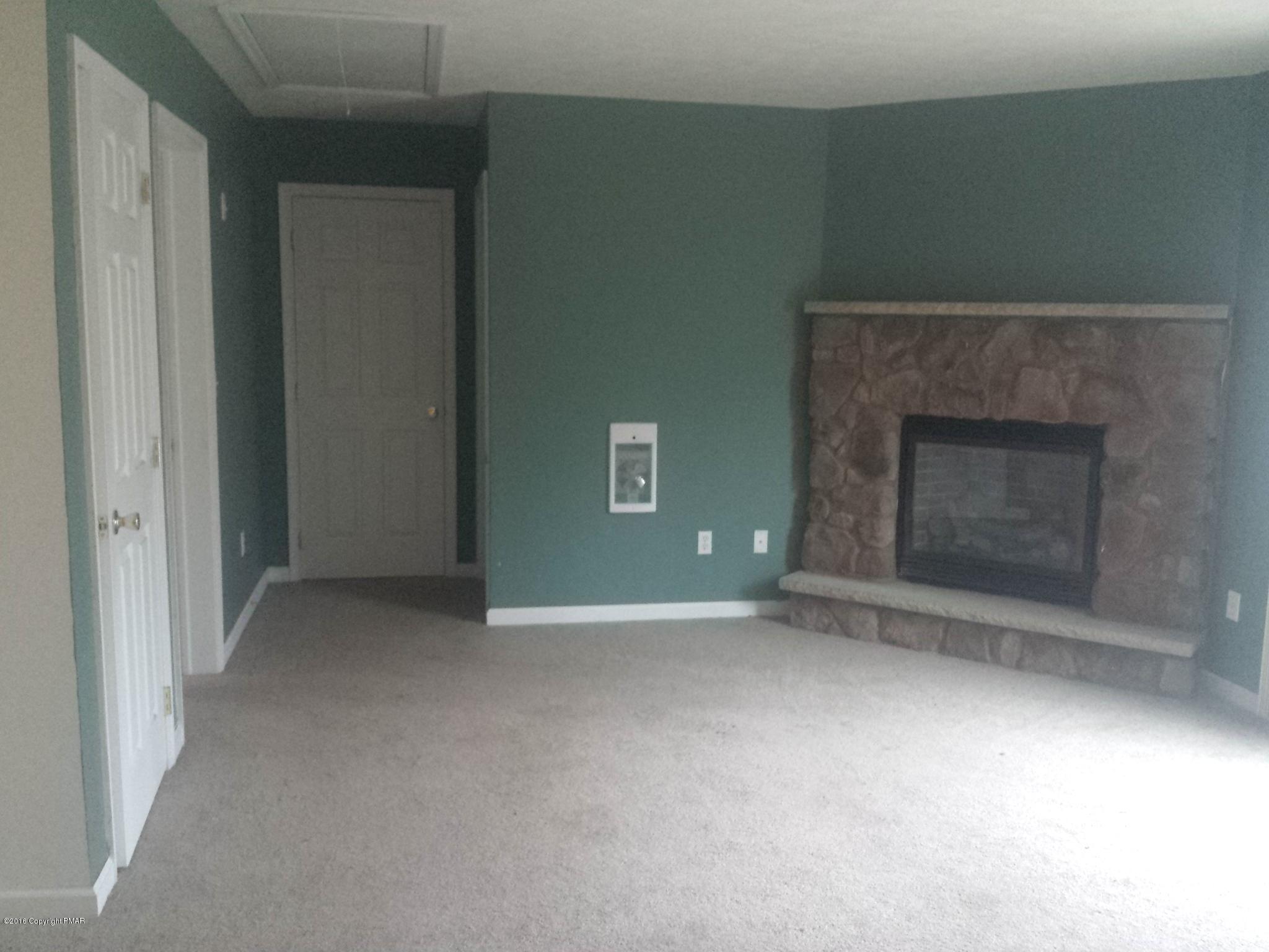 276 Powder Horn Road Henryville, PA 18332 - Photo 4 of 16 an empty room with a fireplace