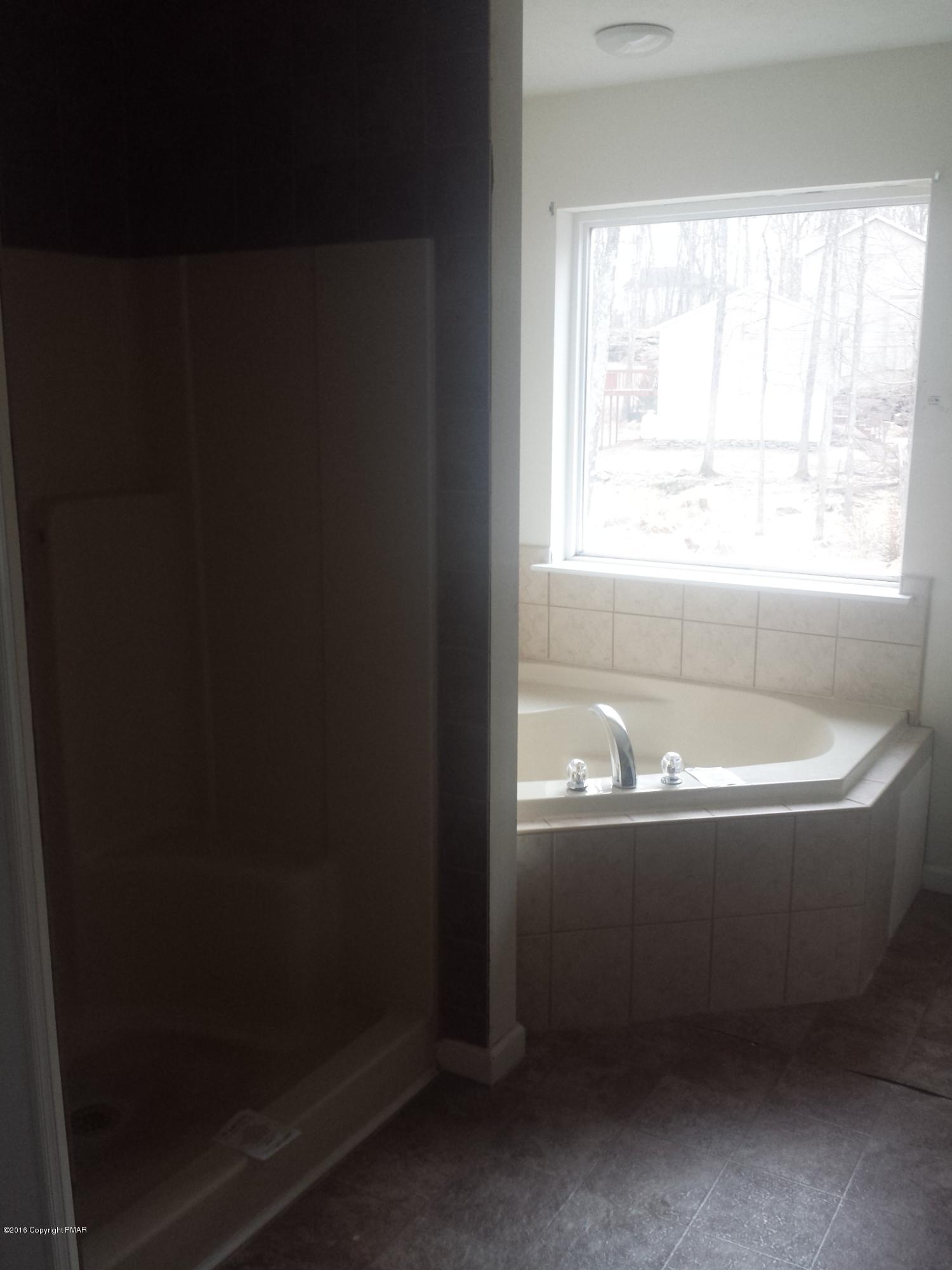 276 Powder Horn Road Henryville, PA 18332 - Photo 8 of 16 a bathroom with a bathtub and shower