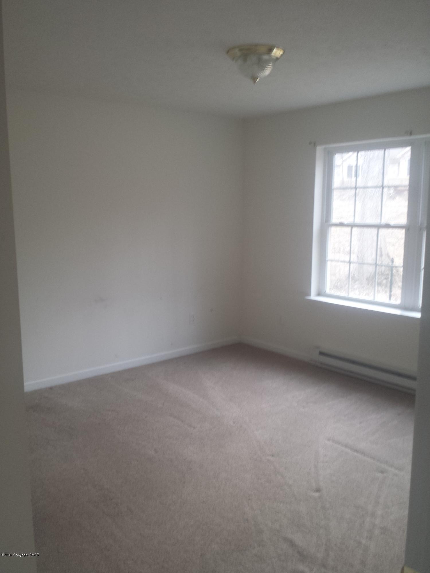 276 Powder Horn Road Henryville, PA 18332 - Photo 9 of 16 an empty room with a window