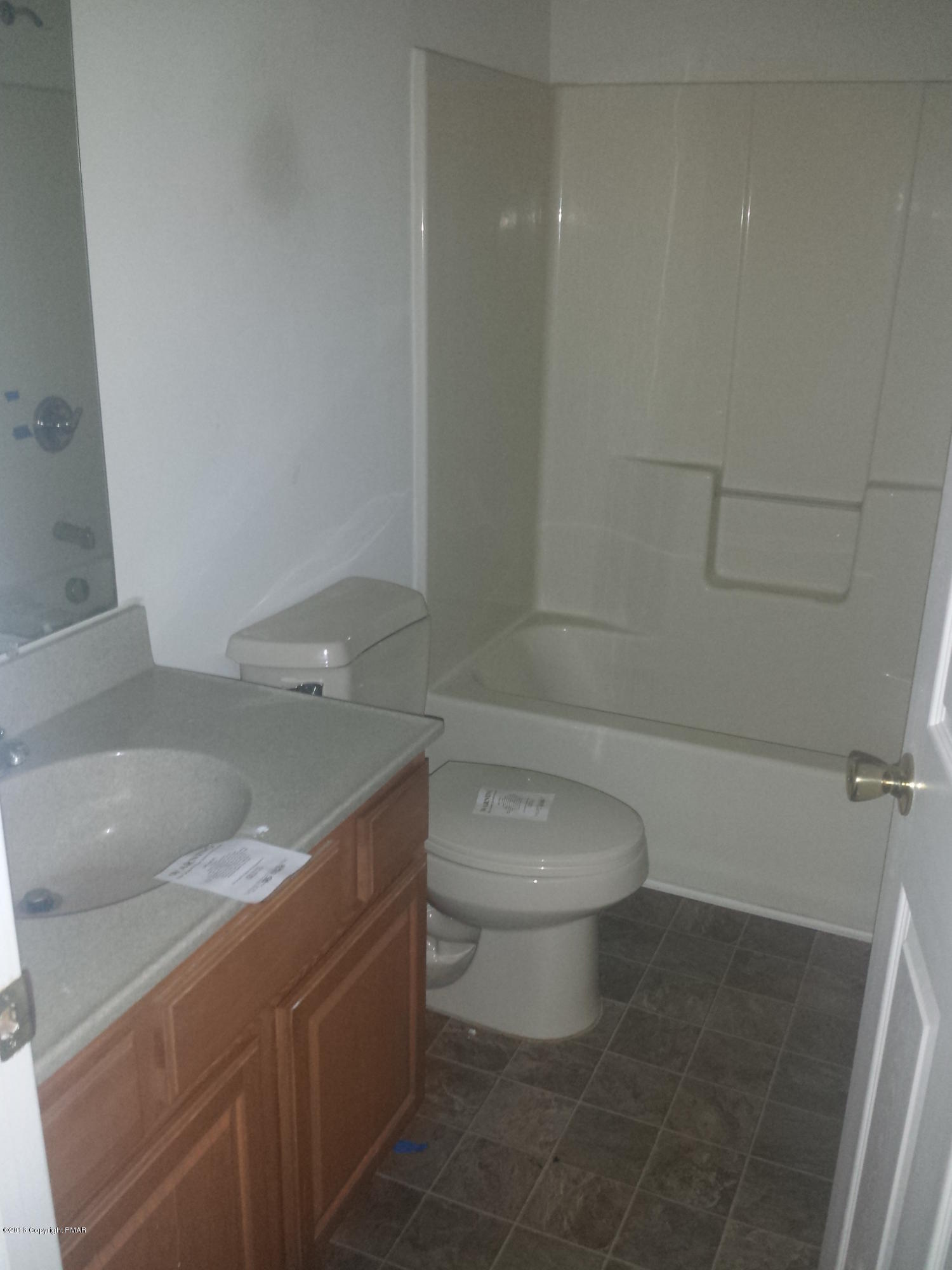276 Powder Horn Road Henryville, PA 18332 - Photo 10 of 16 a bathroom with a toilet a sink and bathtub