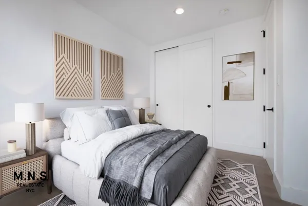 a bedroom with a white bed and a chair