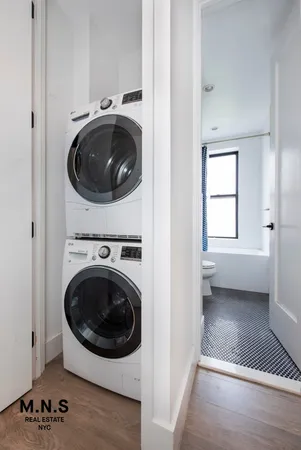 a view of a hallway with washer and dryer