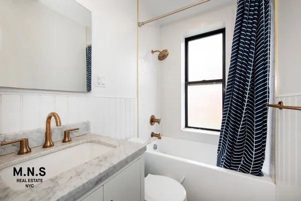 a bathroom with a granite countertop sink toilet and bathtub