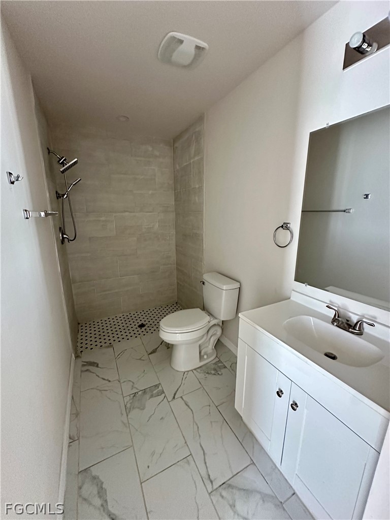 252 Southwest 3rd Street Cape Coral, FL 33991 - Photo 13 of 16 a bathroom with a sink a toilet and shower