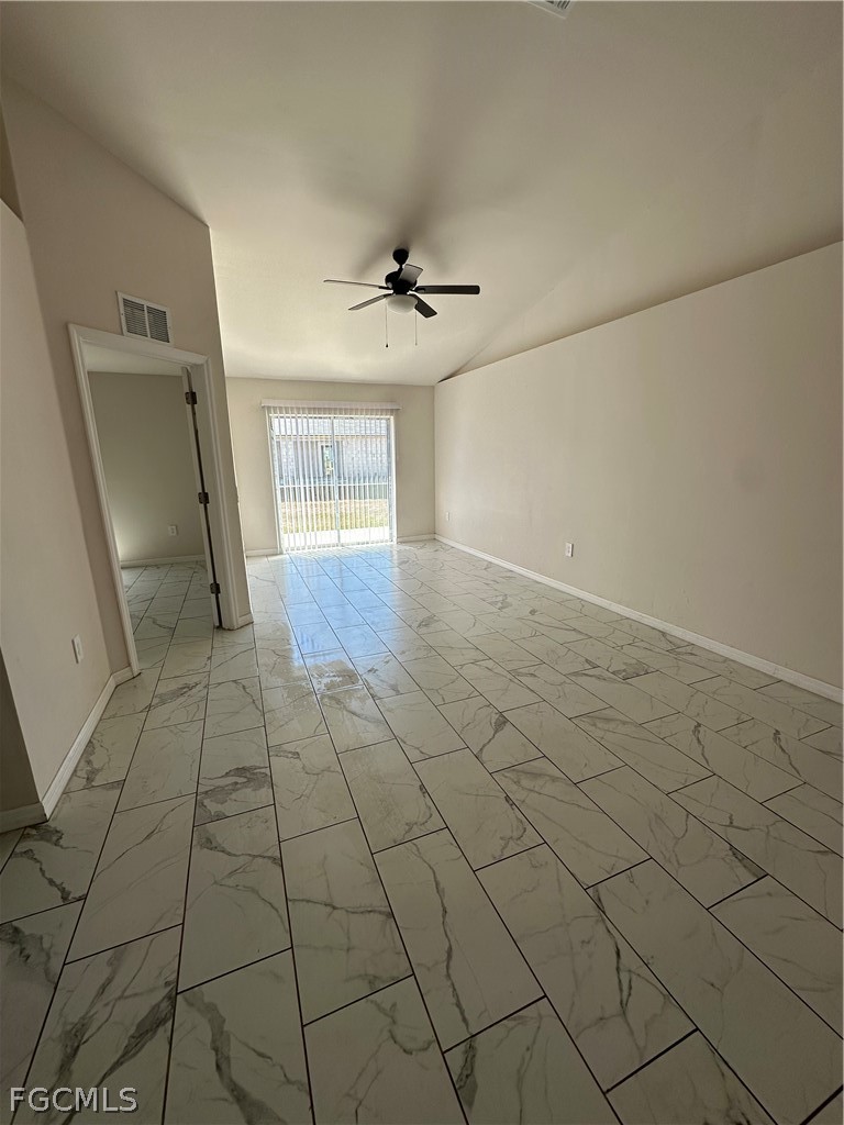 252 Southwest 3rd Street Cape Coral, FL 33991 - Photo 2 of 16 an empty room with windows and fan