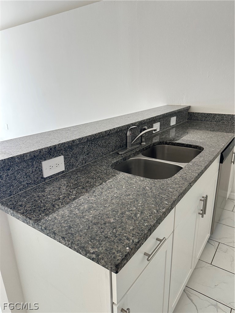 252 Southwest 3rd Street Cape Coral, FL 33991 - Photo 5 of 16 a kitchen with granite countertop a sink and a white stove