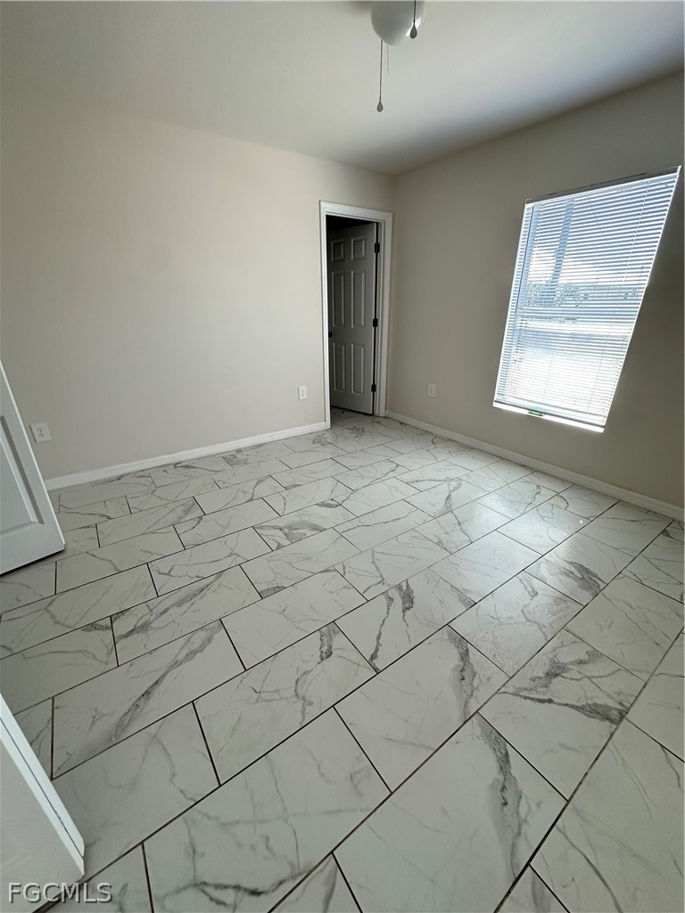 252 Southwest 3rd Street Cape Coral, FL 33991 - Photo 10 of 16 an empty room with windows