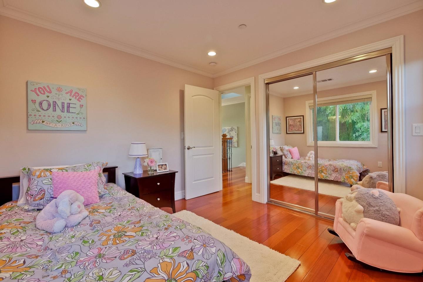 10310 Moretti Drive Cupertino, CA 95014 - Photo 20 of 31 a bedroom with a bed and glass window