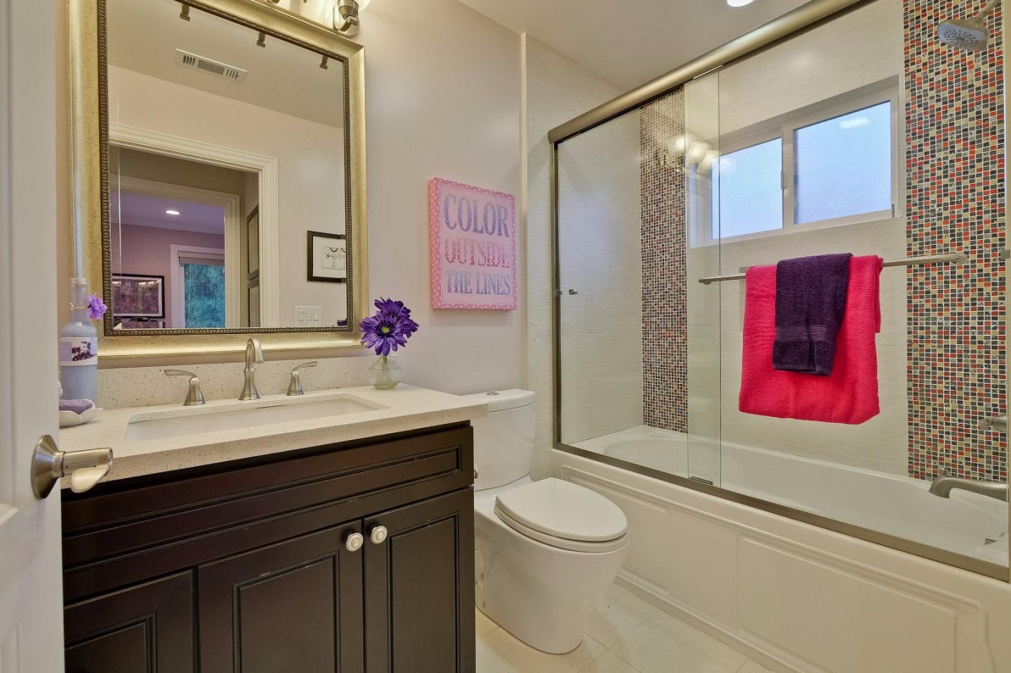 10310 Moretti Drive Cupertino, CA 95014 - Photo 21 of 31 a bathroom with a sink vanity mirror and toilet