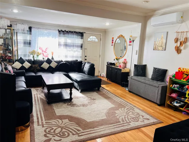 a living room with furniture and a view of kitchen