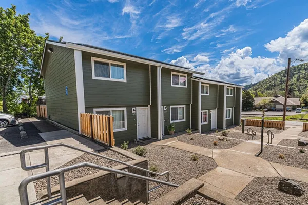 a view of a house with backyard porch and sitting area