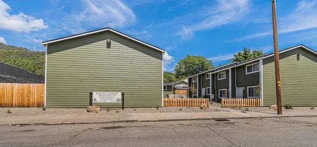 a view of a house with wooden fence