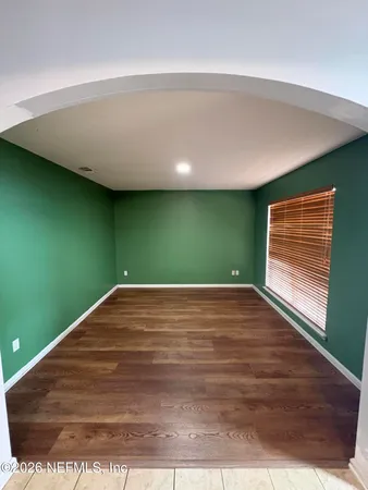 a view of a room with wooden floor