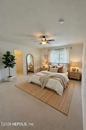 a bedroom with a bed and potted plant