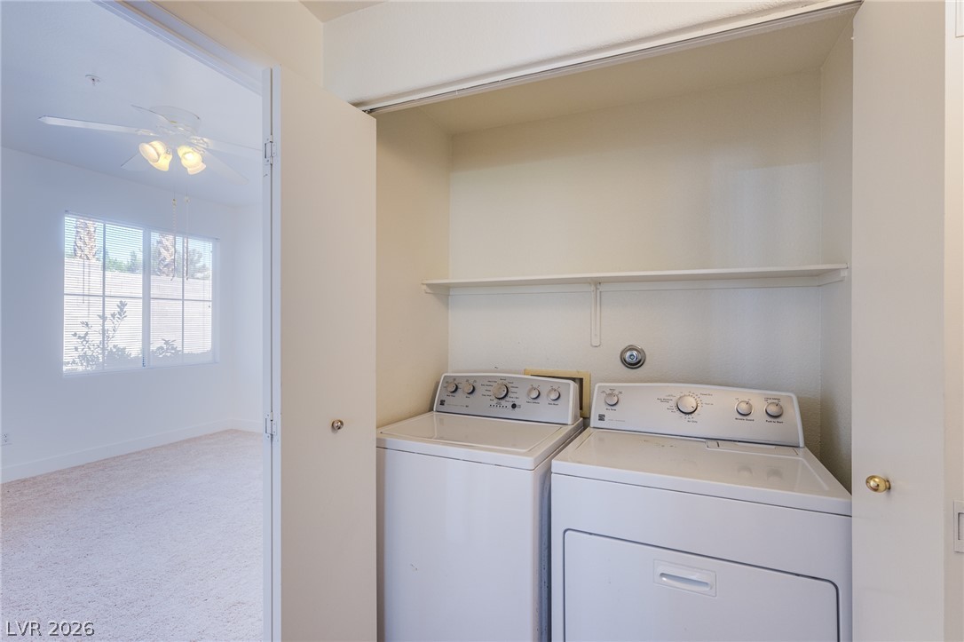 9050 West Warm Springs Road, Unit 1011 Las Vegas, NV 89148 - Photo 10 of 32 Functional laundry space with a washer and dryer provides daily convenience.