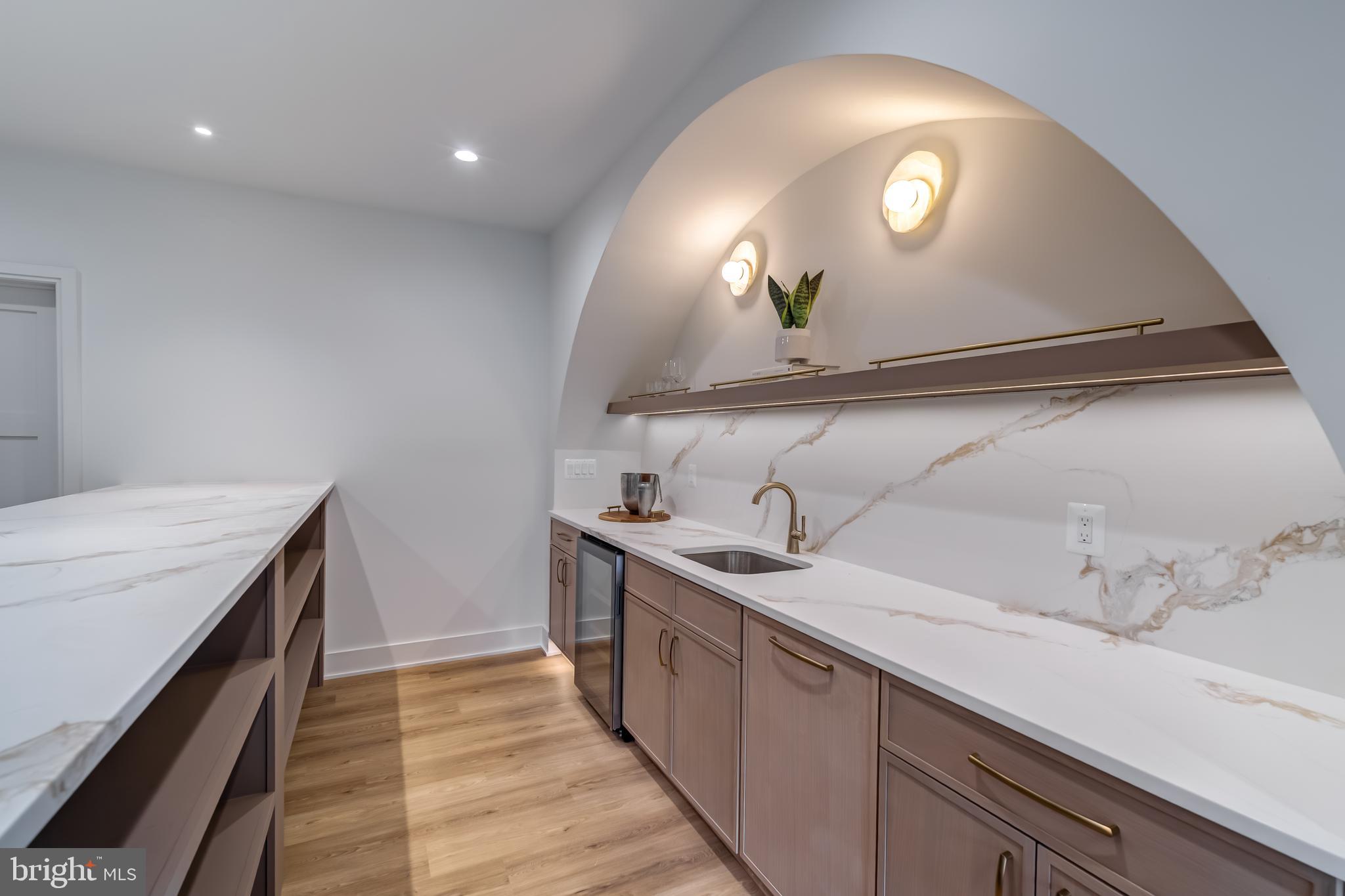 913 Symphony Circle Southwest Vienna, VA 22180 - Photo 126 of 150 a kitchen with a sink and a stove with wooden floor
