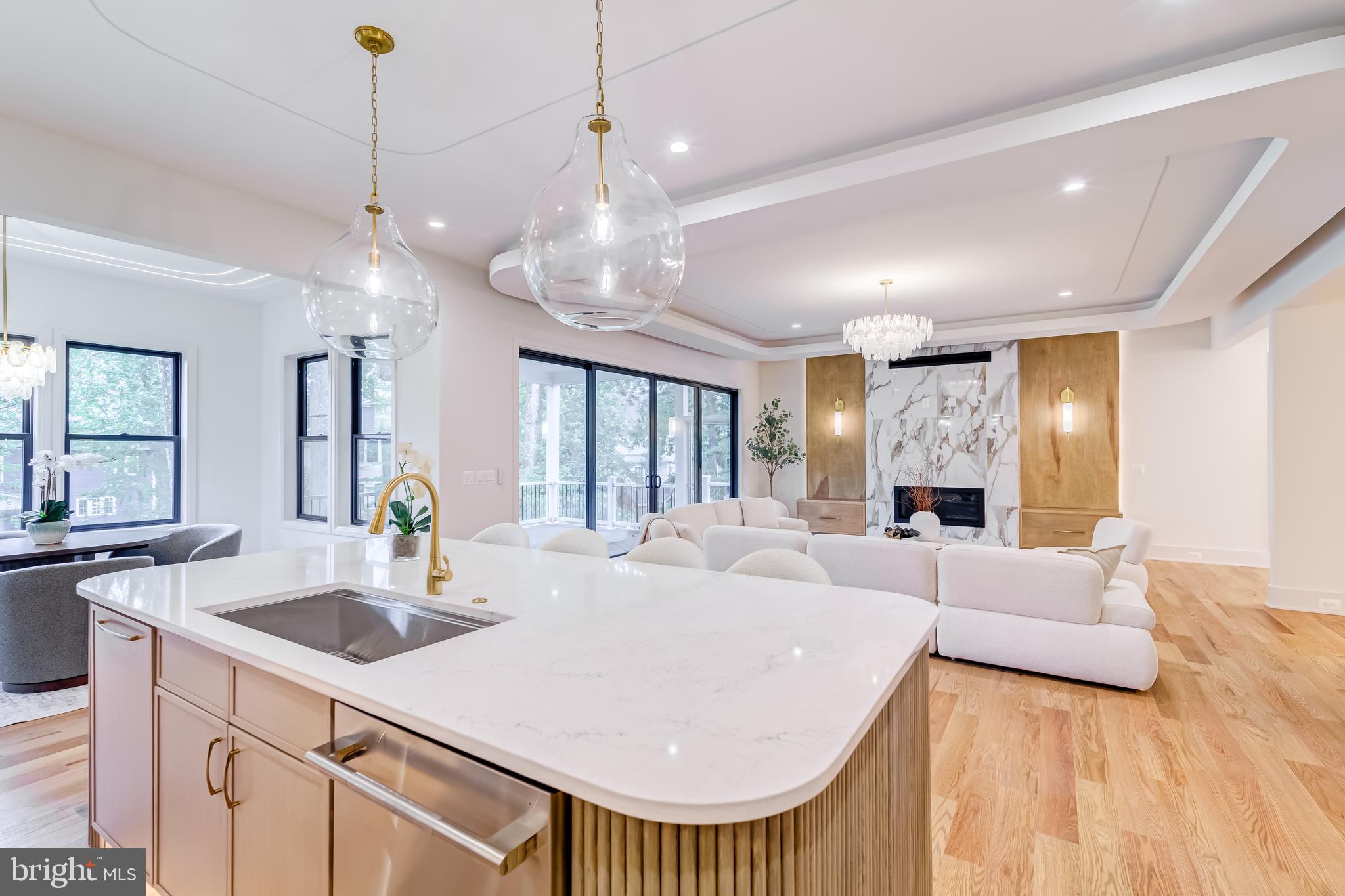 913 Symphony Circle Southwest Vienna, VA 22180 - Photo 14 of 150 a large white kitchen with a large island oven a stove a sink a couch and a dining table