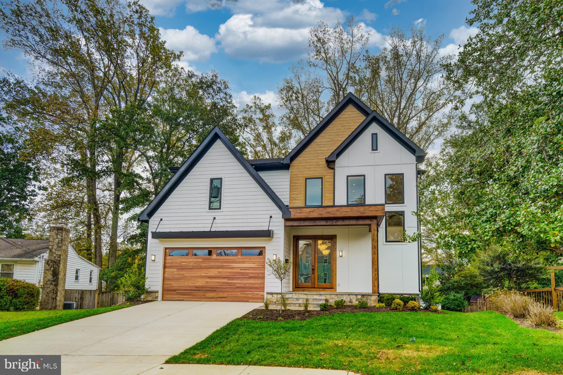 913 Symphony Circle Southwest Vienna, VA 22180 - Photo 2 of 150 a front view of a house with a yard and garage