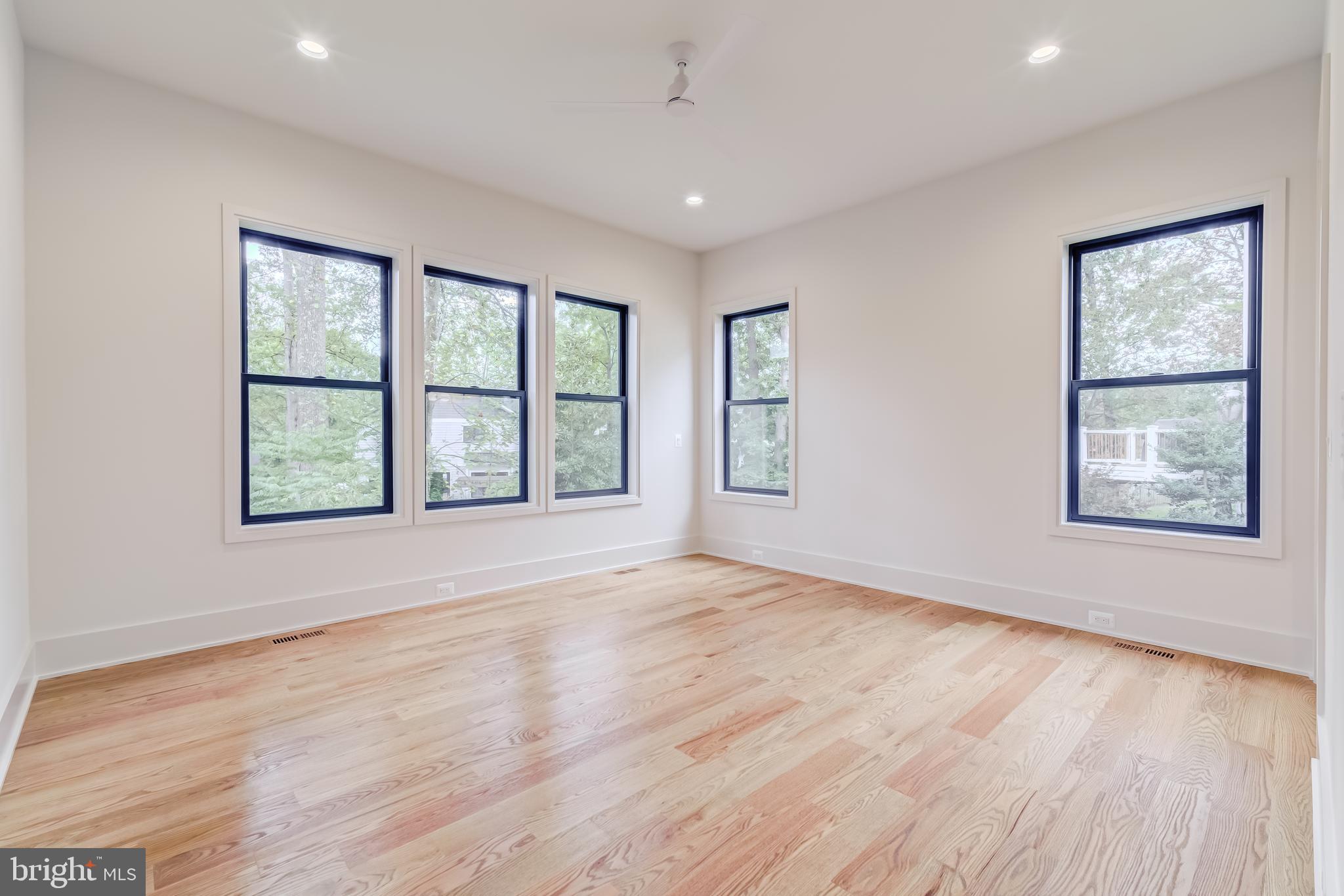 913 Symphony Circle Southwest Vienna, VA 22180 - Photo 41 of 150 a view of an empty room with wooden floor and a window