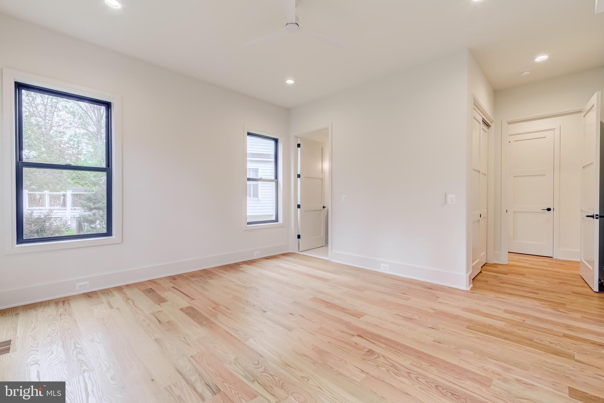 913 Symphony Circle Southwest Vienna, VA 22180 - Photo 42 of 150 a view of an empty room with wooden floor and a window