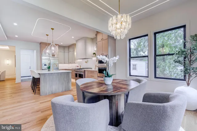 a view of a house with a big yard and large trees