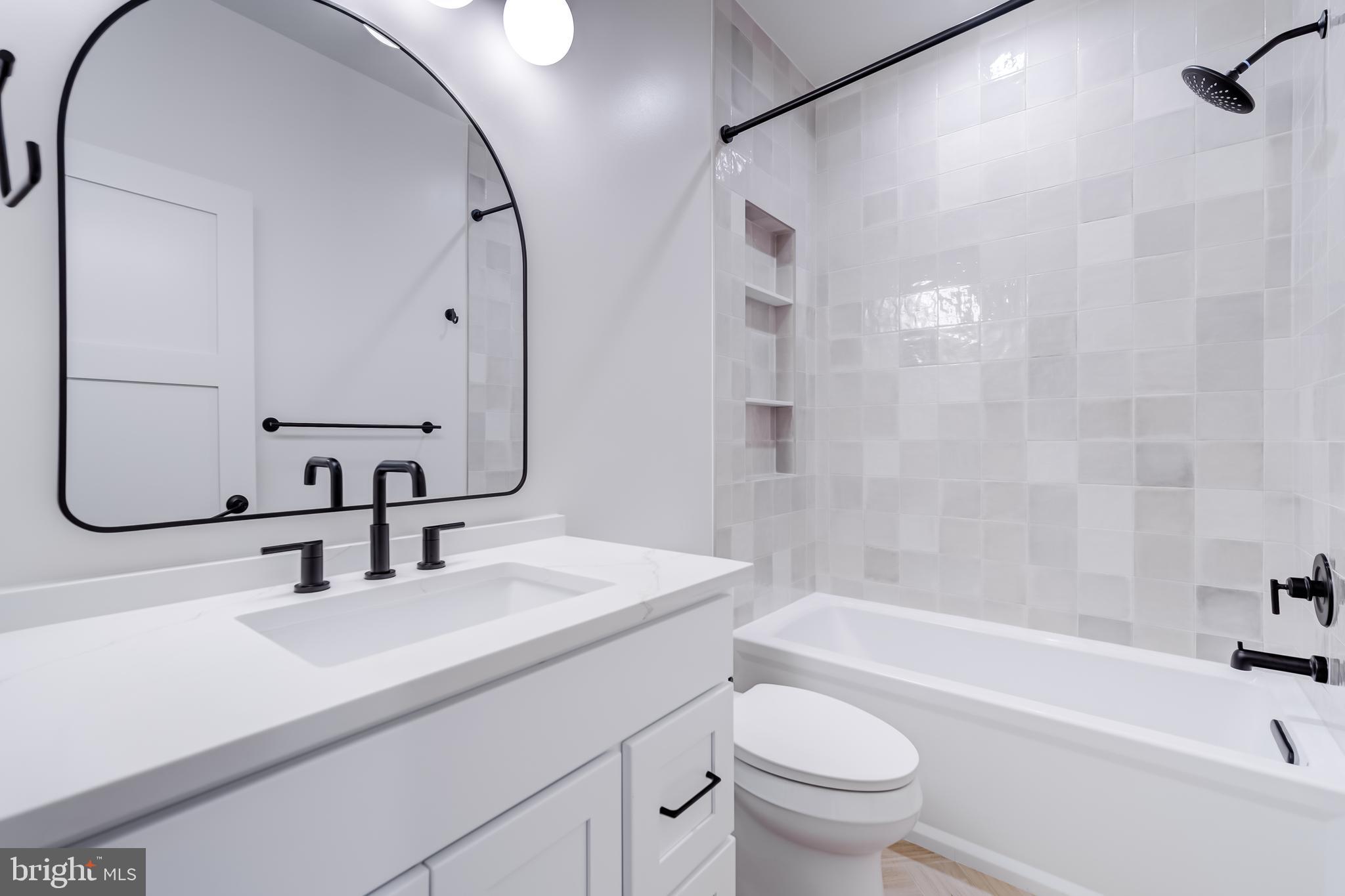 913 Symphony Circle Southwest Vienna, VA 22180 - Photo 64 of 150 a bathroom with a sink a toilet and a mirror