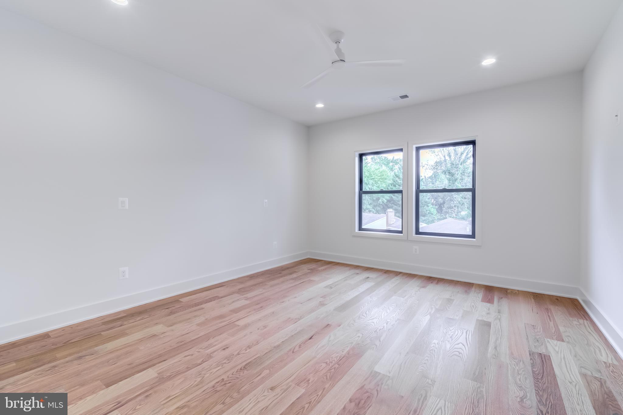 913 Symphony Circle Southwest Vienna, VA 22180 - Photo 66 of 150 an empty room with wooden floor and windows