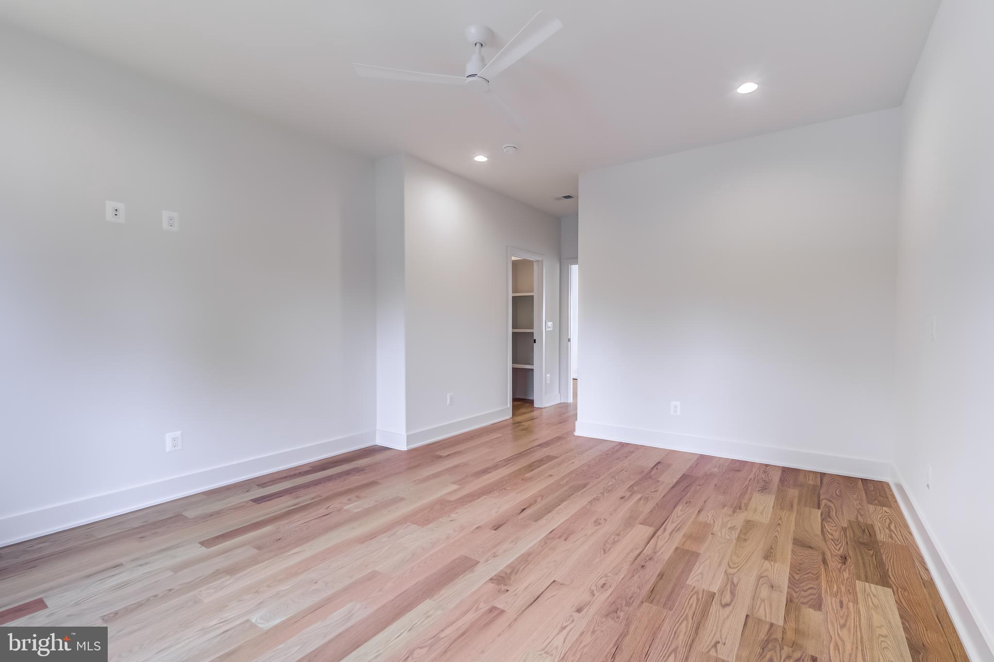 913 Symphony Circle Southwest Vienna, VA 22180 - Photo 68 of 150 a view of an empty room with wooden floor and a window