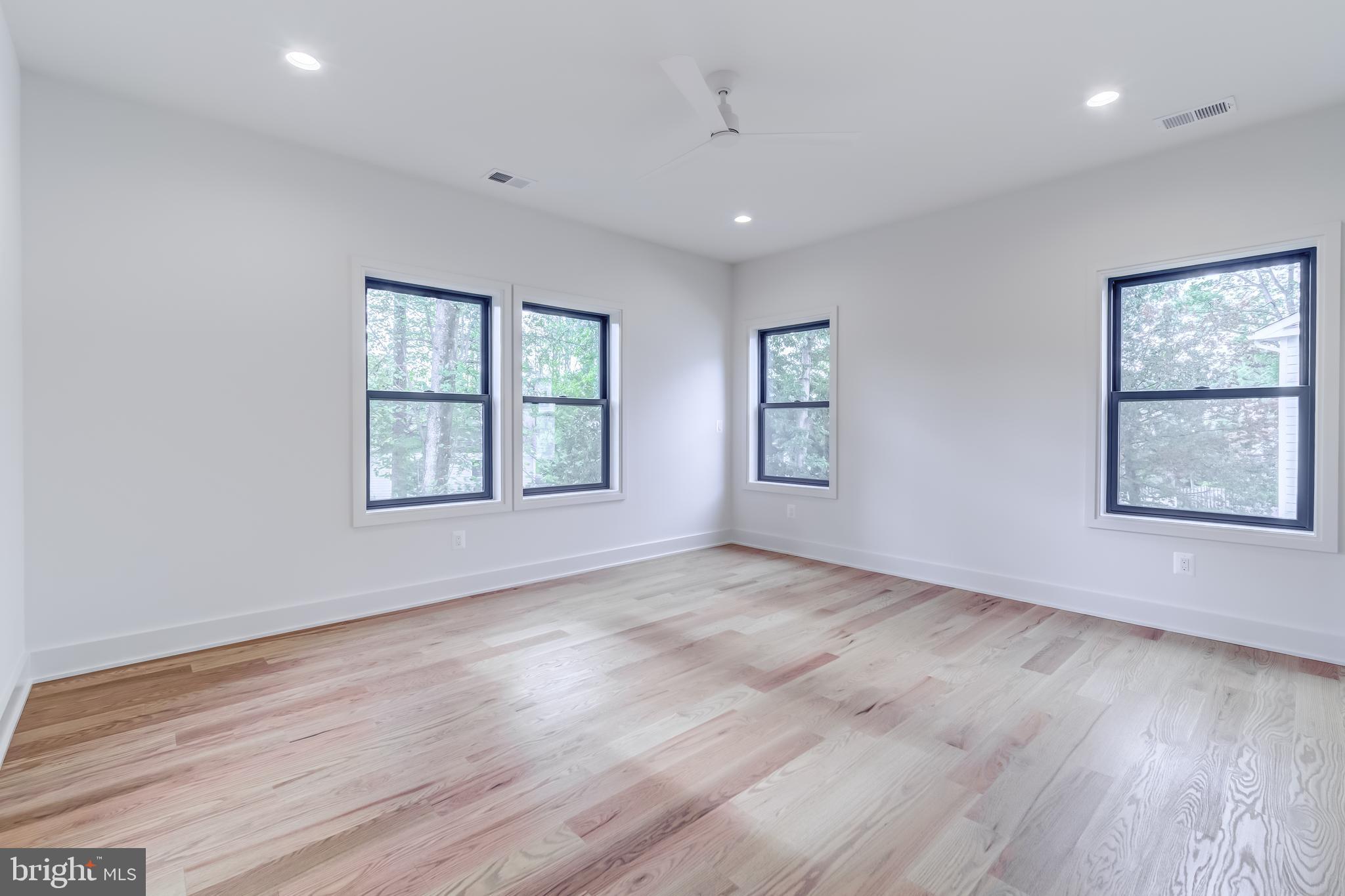 913 Symphony Circle Southwest Vienna, VA 22180 - Photo 80 of 150 an empty room with wooden floor and windows