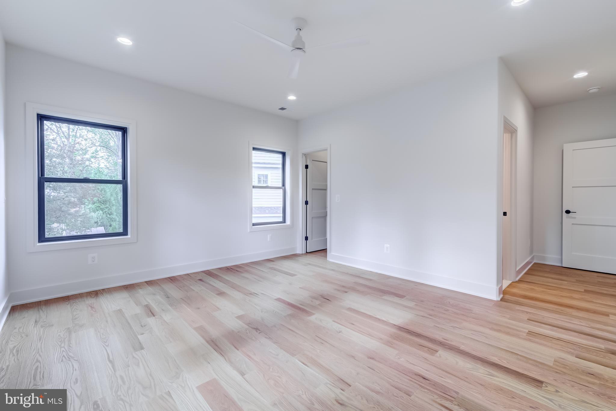 913 Symphony Circle Southwest Vienna, VA 22180 - Photo 81 of 150 an empty room with wooden floor and windows