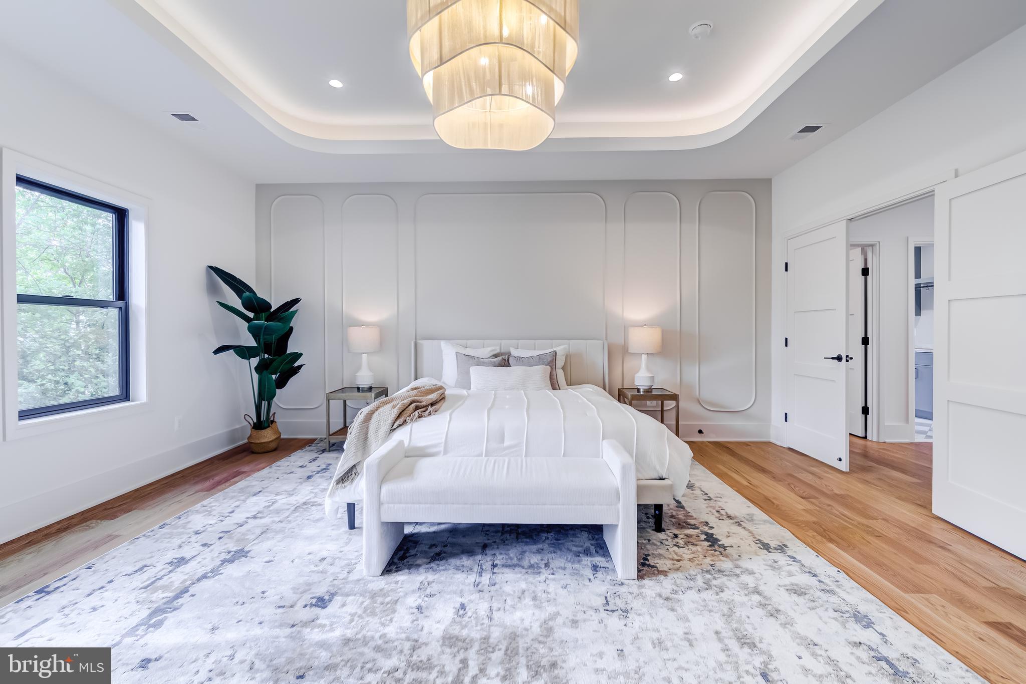 913 Symphony Circle Southwest Vienna, VA 22180 - Photo 86 of 150 a spacious bedroom with a bed and a chandelier