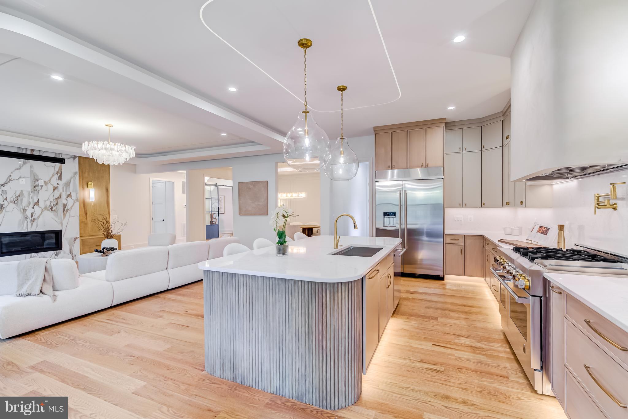 913 Symphony Circle Southwest Vienna, VA 22180 - Photo 10 of 150 a large kitchen with stainless steel appliances kitchen island granite countertop a large kitchen island a stove a sink a refrigerator white cabinets and couches with wooden floor