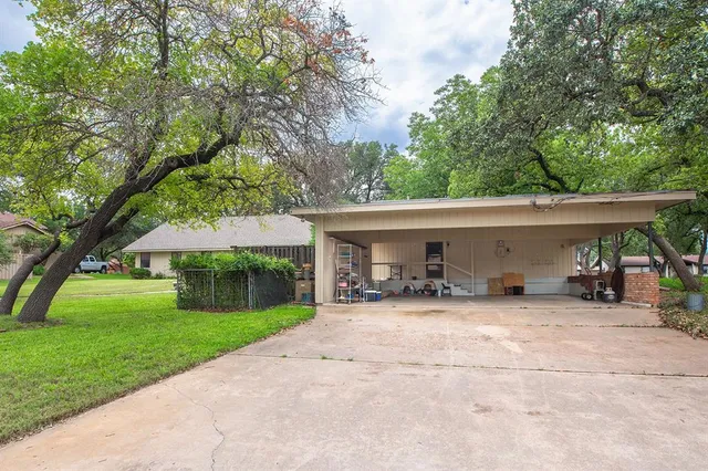 a view of a house with backyard and sitting area