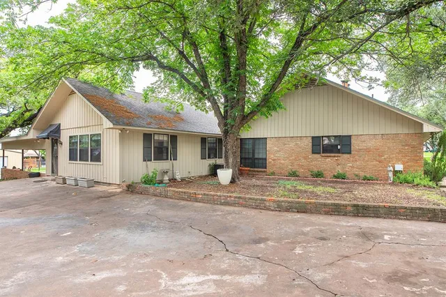 a house that has a tree in front of it
