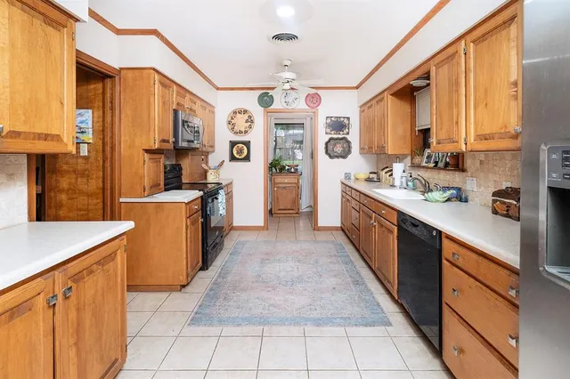 a kitchen with stainless steel appliances a sink stove and cabinets