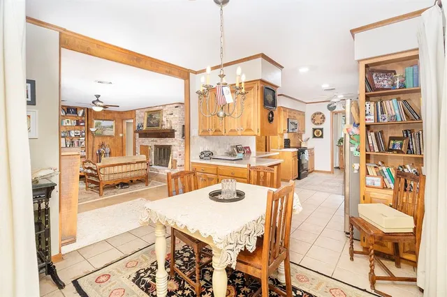 a living room with stainless steel appliances furniture a rug and a large window