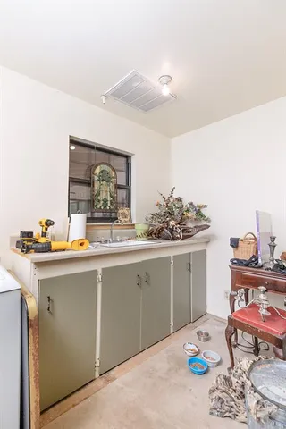 a kitchen with a sink cabinets and wooden floor