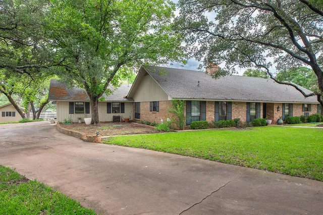 a front view of a house with a yard and porch