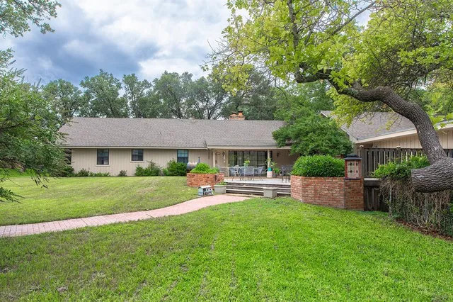 a front view of a house with a garden and patio