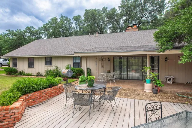 a view of a house with backyard sitting area and garden