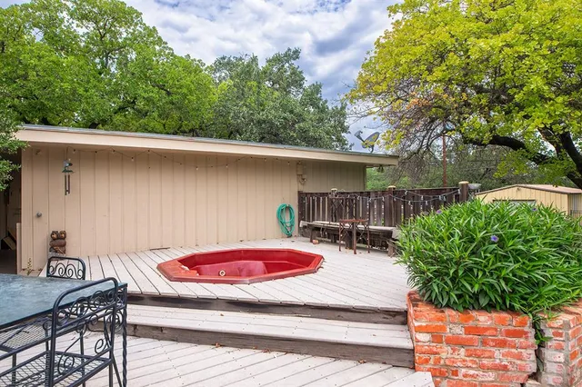a backyard of a house with table and chairs