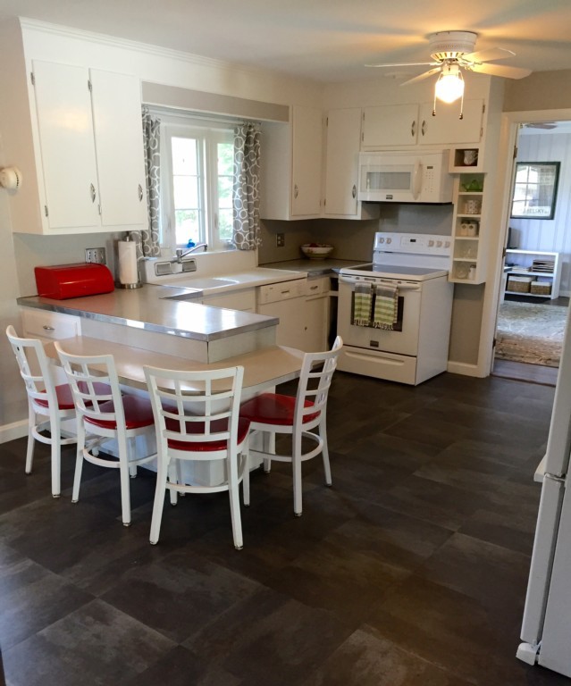 10 Ridgeway Circle Springfield, MA 01118 - Photo 14 of 29 a kitchen with stainless steel appliances kitchen island granite countertop a table chairs sink and cabinets