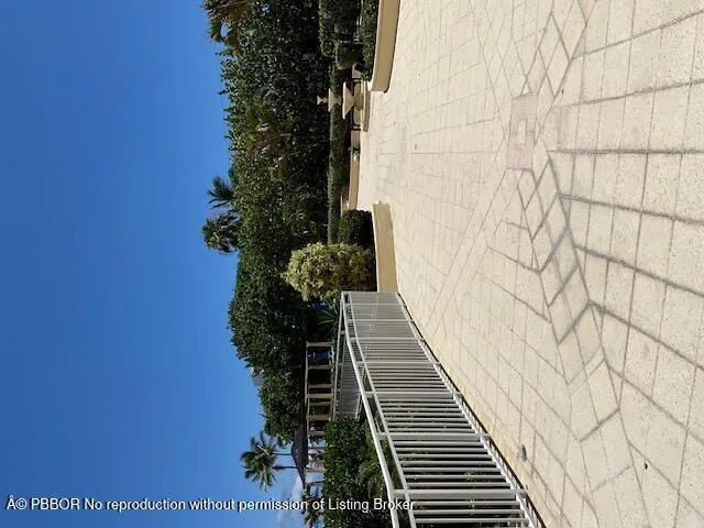 a kitchen with stainless steel appliances a stove a sink a microwave and a refrigerator